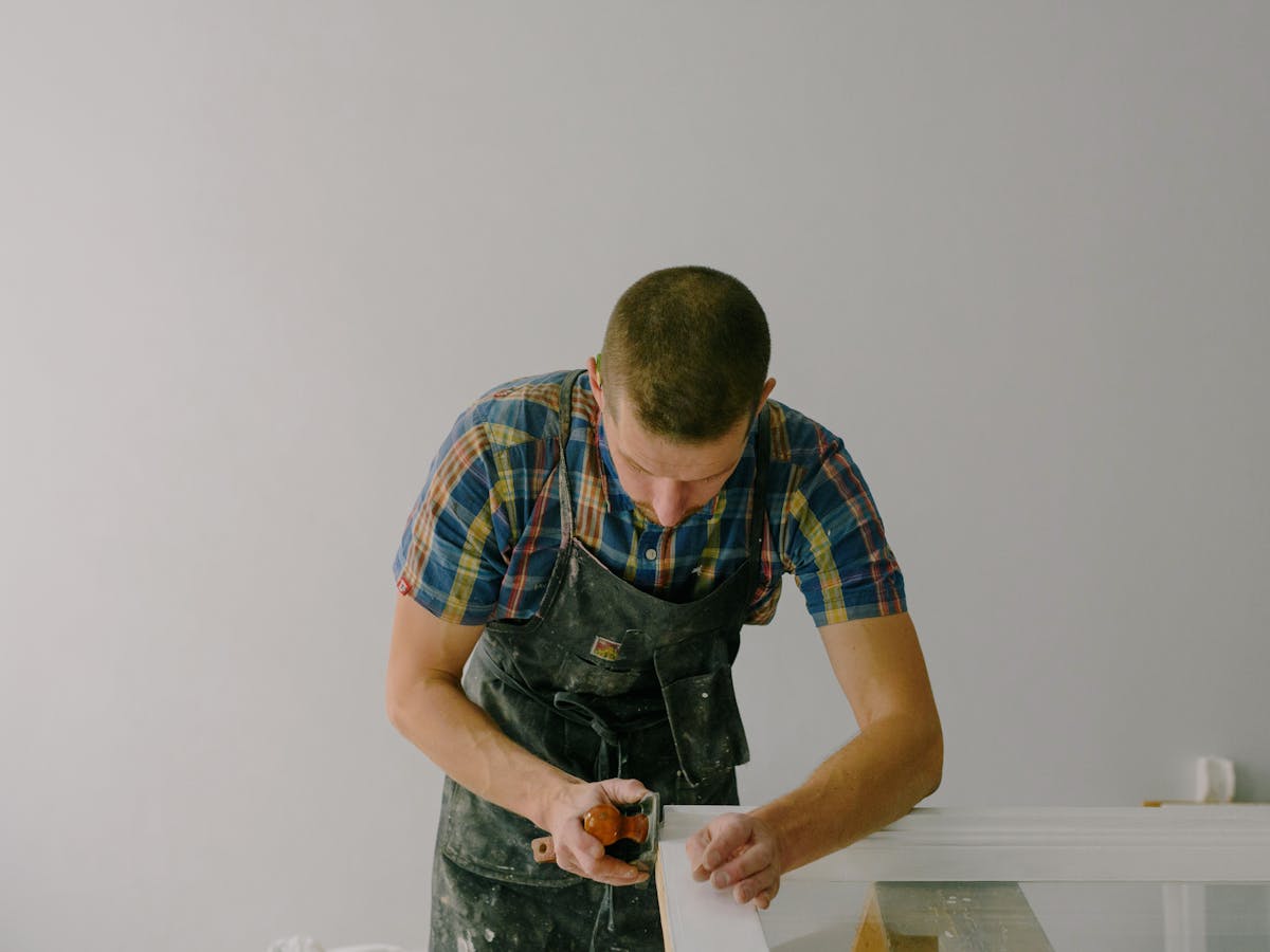 Deelux joiner preparing cabinet components on the workshop bench